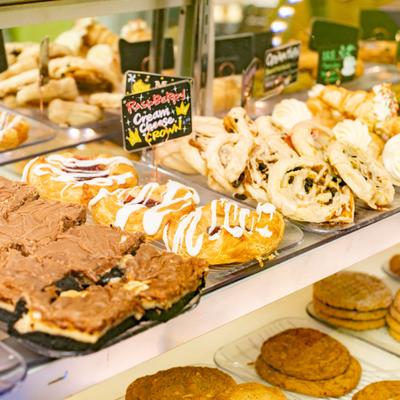 Display case filled with various freshly baked pastries and desserts.