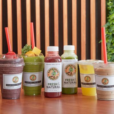 Assorted smoothies and fresh juices on a table.