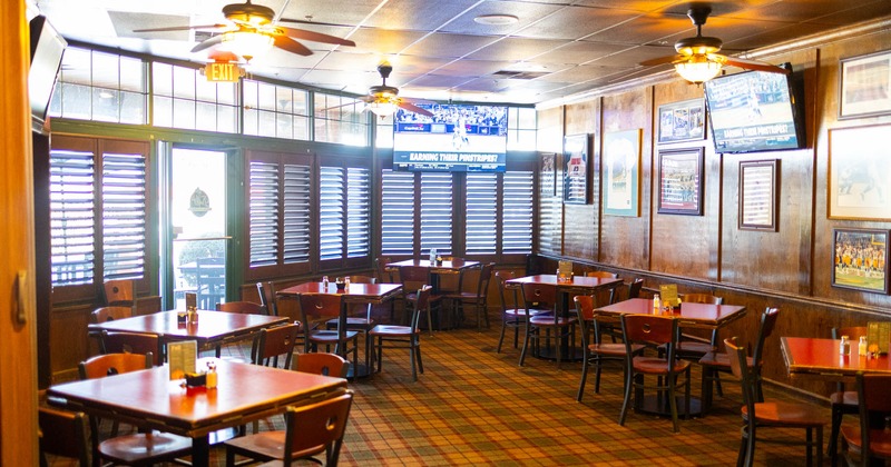 Interior, dining area, tables and chairs ready for guests, restaurant entrance