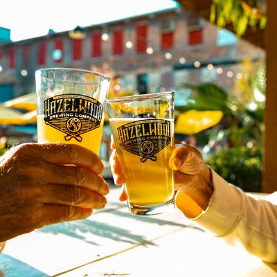 Hands clinking their glasses in a toast.