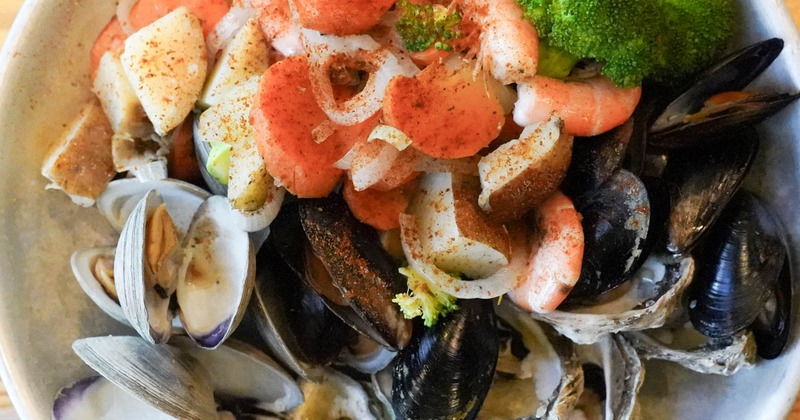 Seafood platter piled with shellfish and broccoli