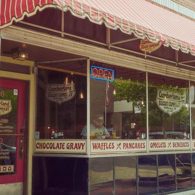 Exterior, awning providing shade over the restaurant front entrance.