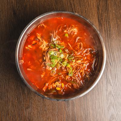 Korean spicy beef soup packed with shredded beef and topped with scallions.
