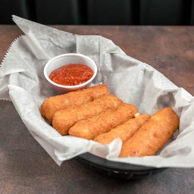 Mozzarella sticks served with marinara sauce in a paper-lined basket.