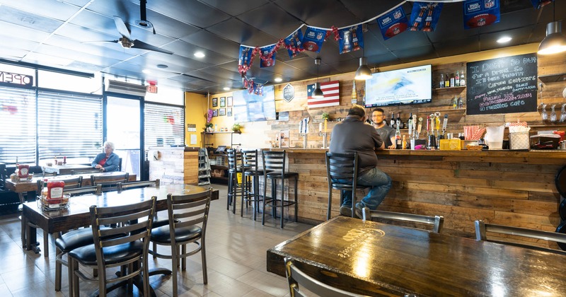 Interior, tables and chairs, bar on the right