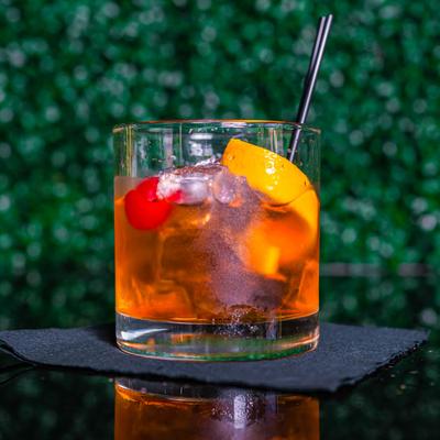 Chocolate City Old Fashioned with citrus peel and cherry.