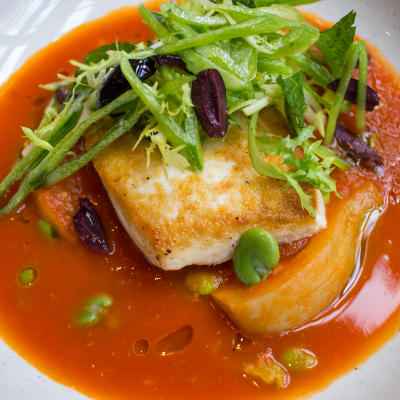 Alaskan Halibut with fennel confit, beans, peas, olives, tomato, shellfish broth