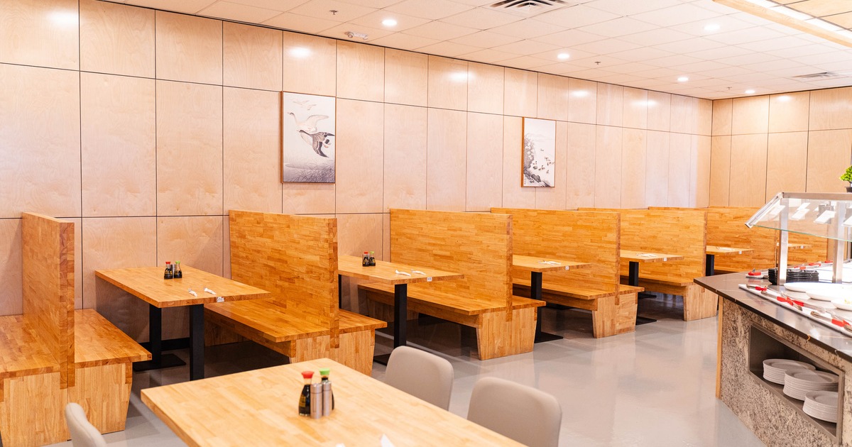 A modern dining area with wooden booths and tables