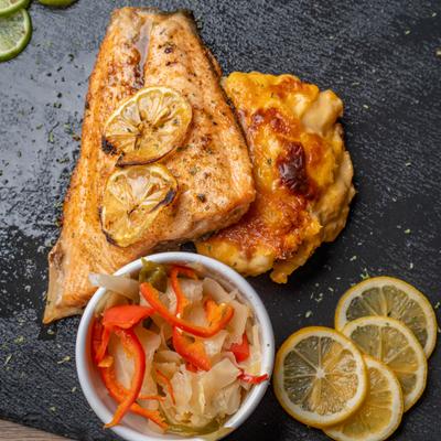 Char-Grilled Salmon served on a slate platter with cabbage and pepper slaw.