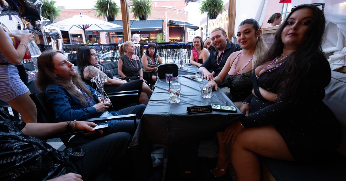 Several people gathered at a table for a celebration
