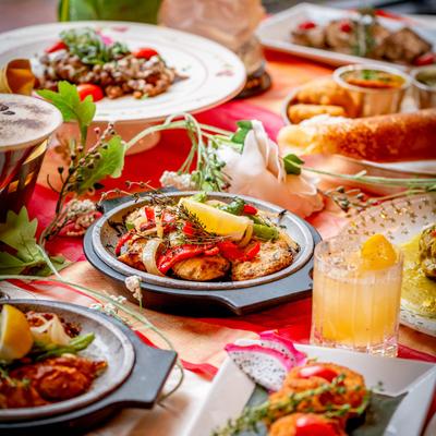 Colorful dishes and cocktails on a table.