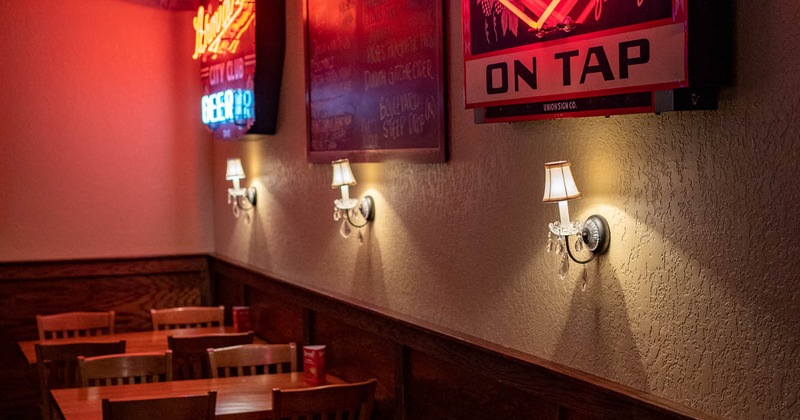 Interior, tables by the wall with lanterns