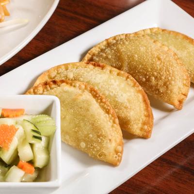 Deep fried minced potato with onion and curry powder, served with cucumber salad.