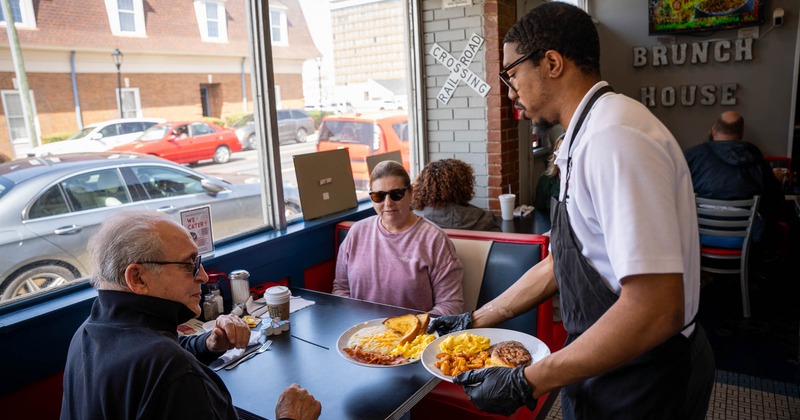 Guests and a staff member servicing them