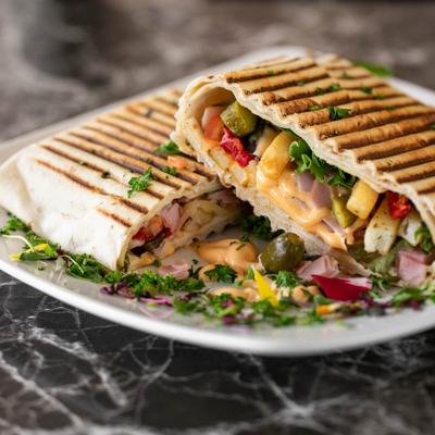 French Taco, with greens, tomato, onion, pickles, cheese, fries, and spicy mayo