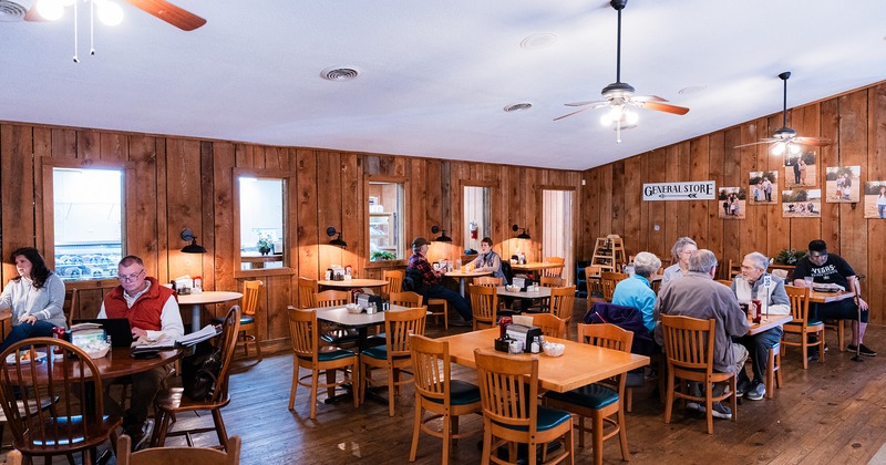 Interior space, dining area, guests chatting and enjoying their food and drinks