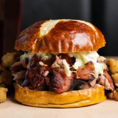 BBQ Sandwich topped with coleslaw, served on a pretzel bun.