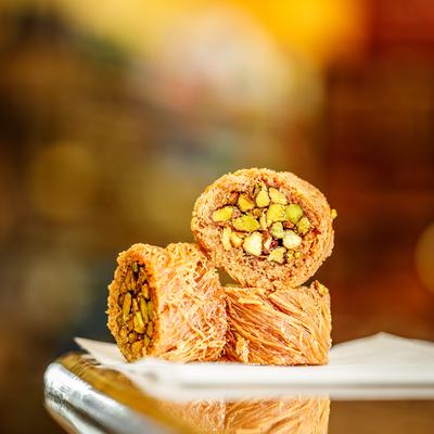 Slices of rolled baklava with pistachios.