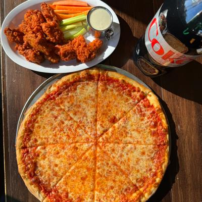 Cheese pizza with buffalo wings, veggies, and a bottle of diet soda.