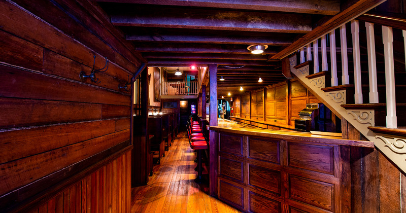 Interior, guest tables, walls decorated with framed paintings