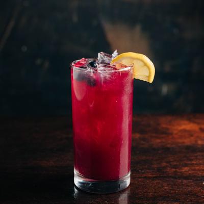 Blueberry Limeade served in a tall glass, with lemon slice.