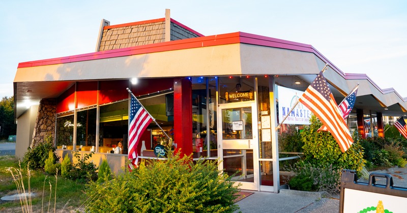 Exterior, angle view to restaurant, entrance, american flags, sign