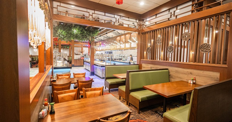 Interior, dining area, seating booths with tables, regular tables for four, carpet flooring