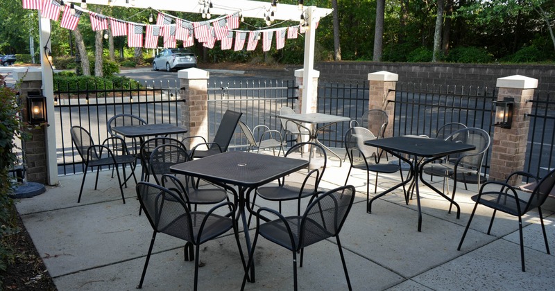 Outdoor patio with black metal tables and chairs