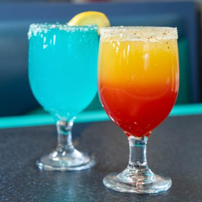 Two different cocktails served on the counter.