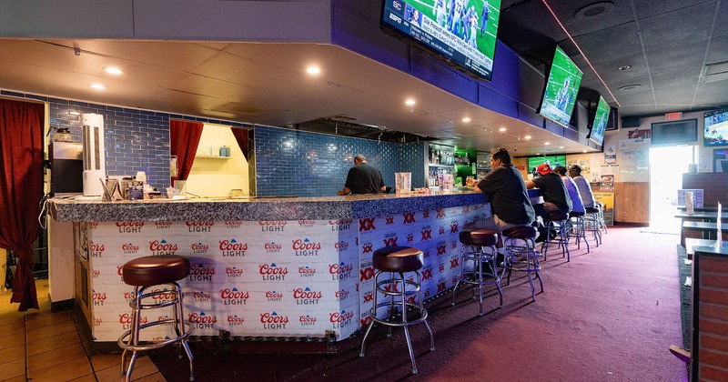 Interior, bar area, TV sets above the bar