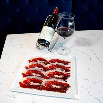 Sliced Iberian ham, and red wine.