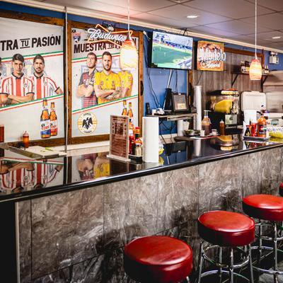 Interior, food counter with stools.