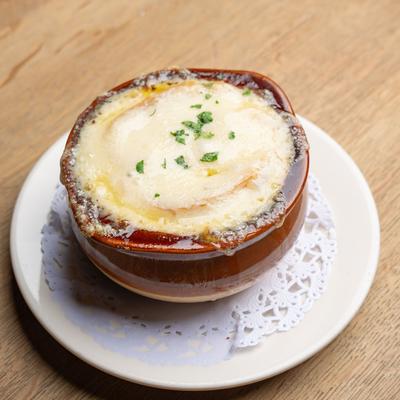French onion soup topped with melted cheese in a bowl.