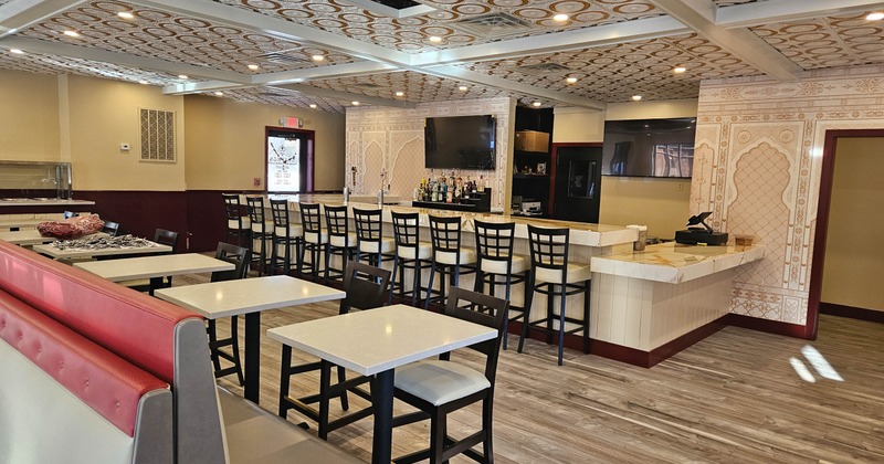 Interior of a restaurant with a bar, tables, and chairs
