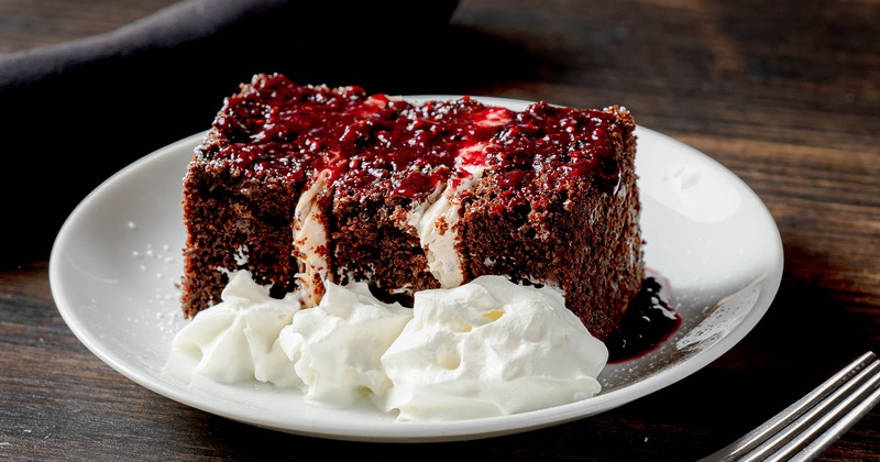 Chocolate cake, with cream, and raspberry sauce