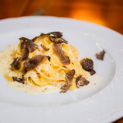Creamy tagliatelle pasta topped with shaved black truffles.
