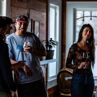 People talking over drinks at a bar.