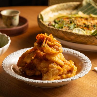 A serving of Crispy Sweet & Sour Pork, accompanied with other dishes.