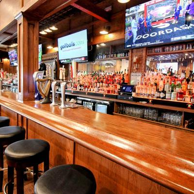 Interior, bar, chairs, screens above.