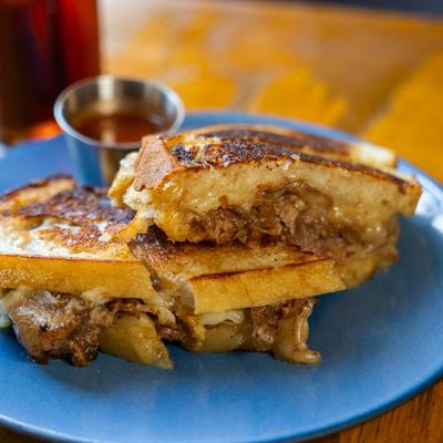 Pork grilled cheese sandwich with dipping sauce.
