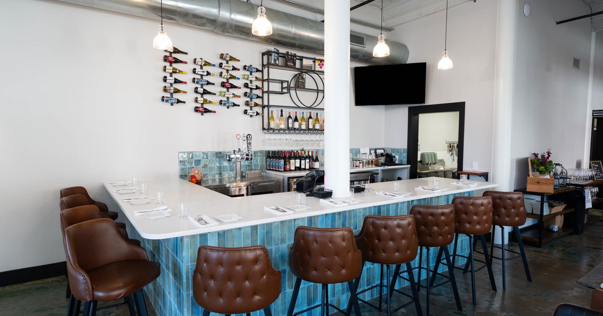 Bare area, neatly lined up bar stools