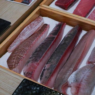 Sliced fish fillets in boxes.