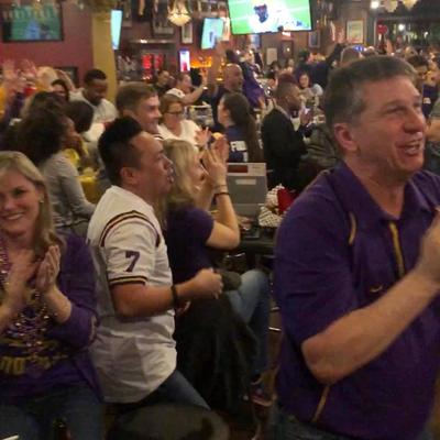 Purple and white jerseys, people cheering