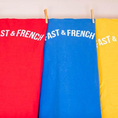 Worker uniforms in various colors, hanging on a wire