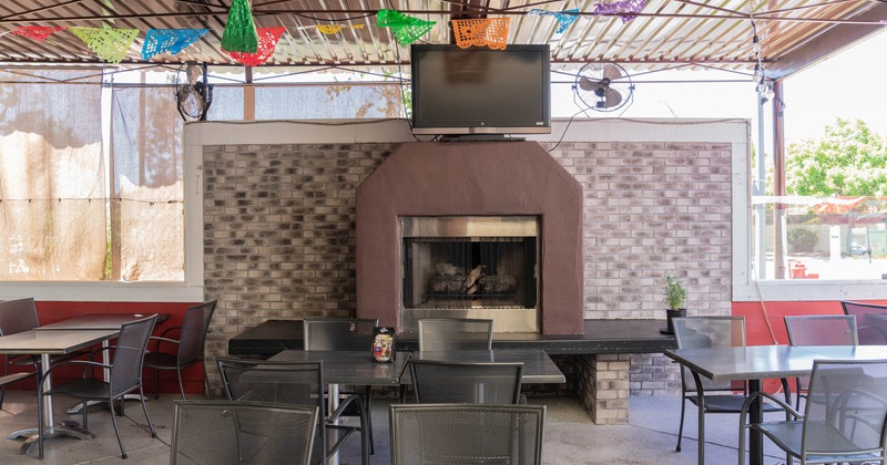 Interior, tables and chairs, fireplace in the back