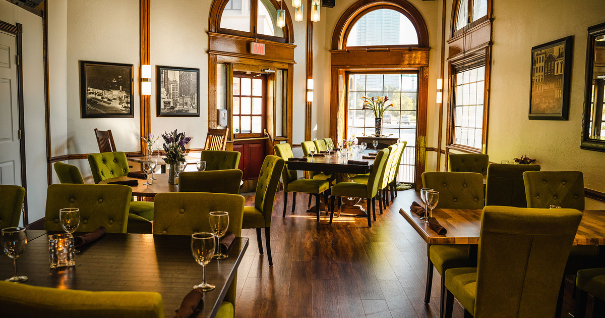 Interior, wide shot of the Parkview room, wooden top tables ready for guests
