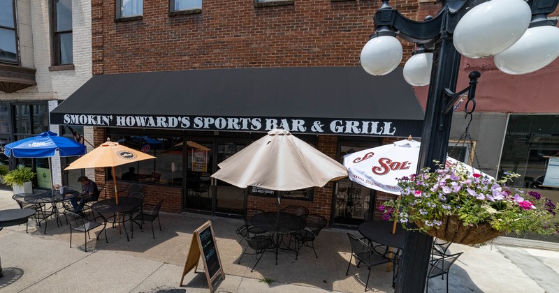 Exterior, table and chairs under the parasols in front the restaurant