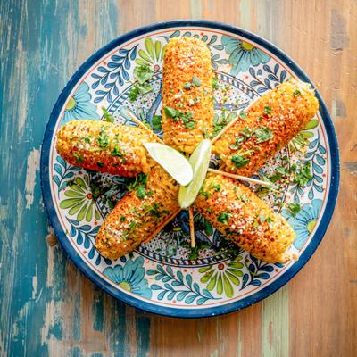 Five pieces of corn with spices, top view
