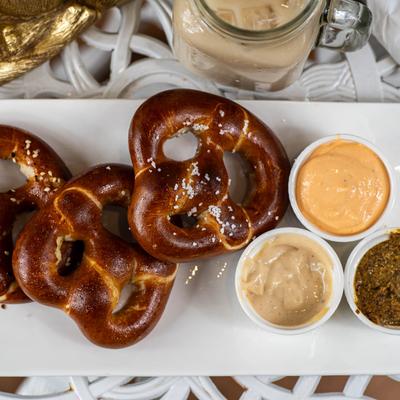 Pretzel trio with ale mustard, garlic aioli, and cheddar cheese for dipping.