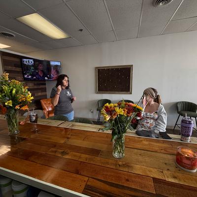 People seating and standing in front of the bar.